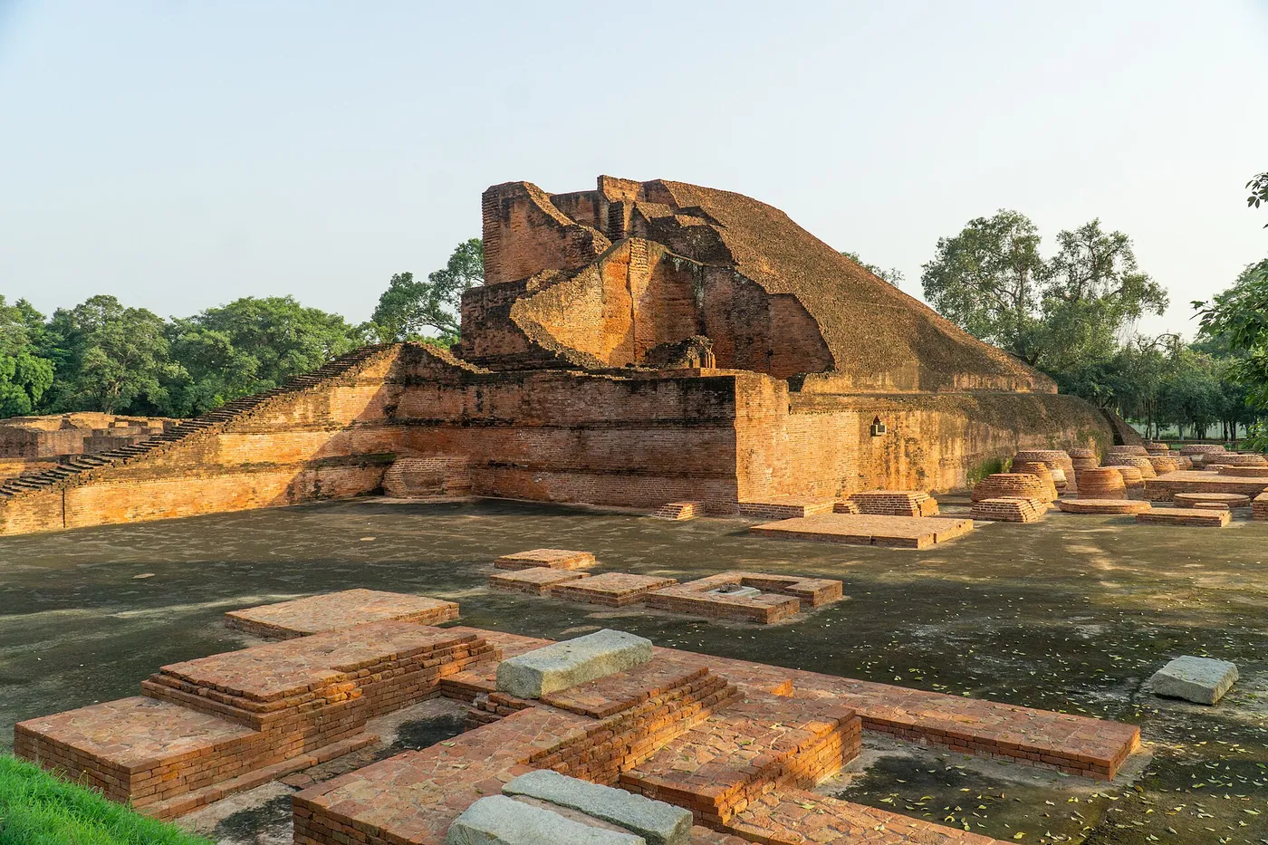 Temple 3 (the Sariputta stupa) at the excavated site of Nalanda, Bihar, its brick core enlarged in successive building phases. Seven centuries of learning, now a groundwork one can walk.